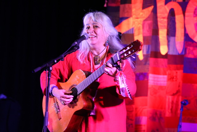 Performer, Kavisha Mazzella, playing guitar